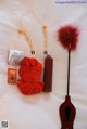 A red rope, a red duster, and other items on a bed.