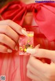 A woman in a red dress holding a packet of candy.