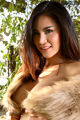 A woman in a fur coat posing for a picture.