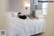 A woman laying on a bed in a hotel room.