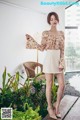 A woman standing on a wooden bench in a room.