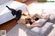 A woman laying on a bed with pillows on the floor.