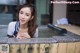 A woman leaning over the edge of a hot tub.