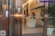 A woman standing at the front desk of a hotel.