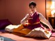 A woman in a korean dress sitting on a bed.