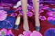 A close up of a woman's legs wearing a pair of shoes.