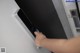 A person is opening a refrigerator door with a key.