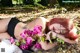 A woman laying on the ground next to a bunch of flowers.