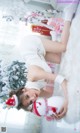 A woman laying on top of a white rug next to a snowman.