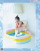 A woman sitting on a chair in an inflatable pool.