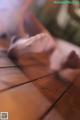 A close up of a person's feet on a wooden floor.