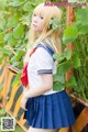 A woman in a school uniform posing for a picture.