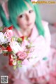 A woman in a pink dress holding a bouquet of flowers.