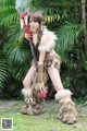 A woman dressed in a furry outfit holding a sword.