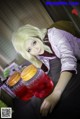 A woman sitting at a table with two jars of juice.