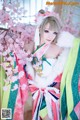 A woman in a colorful kimono posing for a picture.