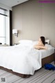 A woman laying on a bed in a hotel room.