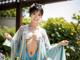 A woman in a blue and white kimono posing for the camera.