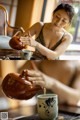 A woman pouring tea into a cup on a table.