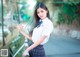 A woman in a school uniform posing for a picture.