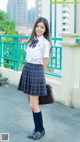 A woman in a school uniform posing for a picture.