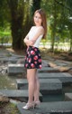 A woman standing on some steps in a park.