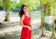 A woman in a red dress posing for a picture.