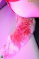 A close up of a pink fur collar on a mannequin.