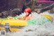 A woman in a yellow and green raft on a river.