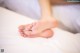 A close up of a person's feet on a bed.