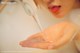 A woman is washing her hands under a faucet.