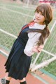 A woman in a school uniform posing for a picture.