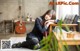 A woman sitting on the floor in a room with a guitar.