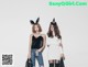 two girls in bunny ears standing next to each other