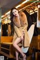 A woman sitting on a chair in a clothing store.