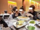 A group of people sitting at a table eating food.